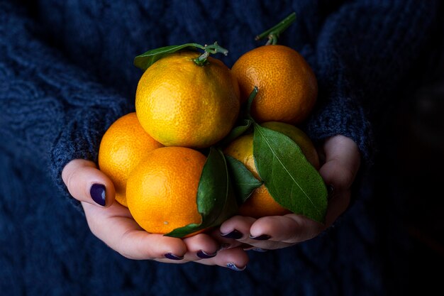 Fresh juicy tangerines or mandarins, clementines with leaves