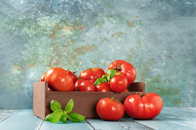 Fresh and juicy tomatoes in a wooden box