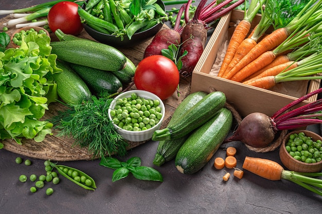 Fresh, juicy vegetables and herbs on a brown background. Side view, horizontal. Vegetable background.