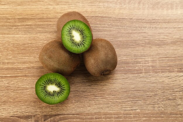 Fresh kiwi fruits served on wooden background selected focus image close up