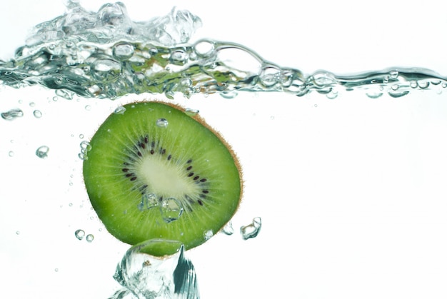 Fresh kiwi jumping into water