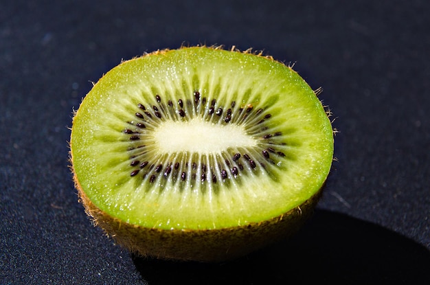 Fresh kiwi open in half on white background and the seeds inside the fruit.