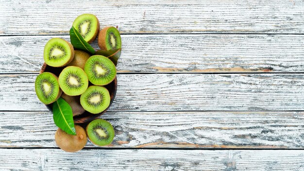 Fresh kiwi on a white wooden table Rustic style Fruits Top view Free space for text