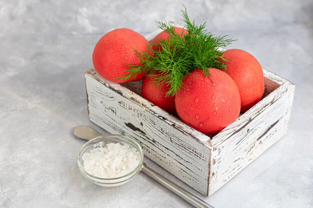 Fresh large tomatoes in a wooden crate