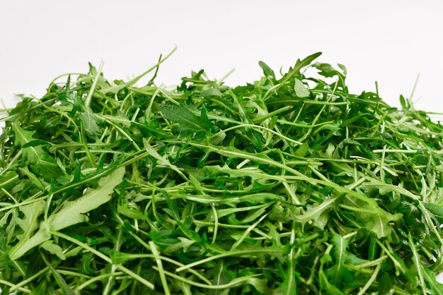 Fresh leaves of arugula as background.