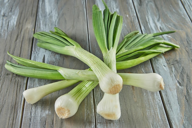 Fresh leek stacked on wooden gray background