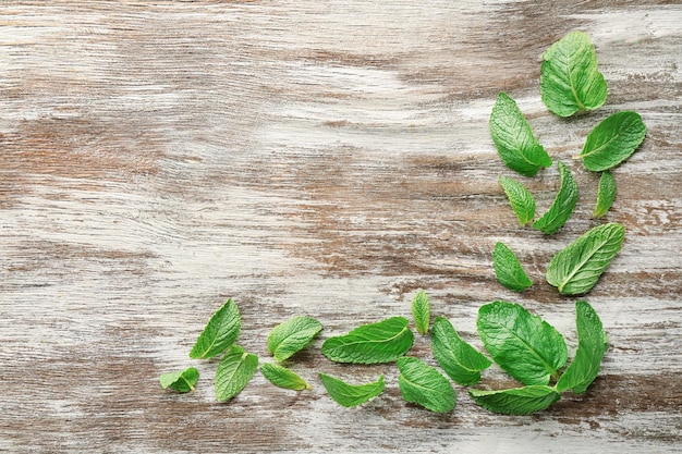 Fresh lemon balm leaves on wooden table