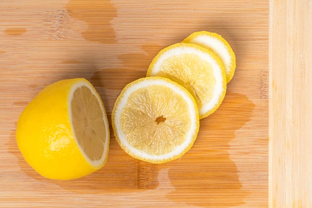 Fresh lemon cut into slices on a cutting board