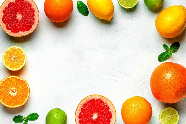 Fresh lemon orange grapefruit lime green leaves on light background top view citrus juice concept vitamin c fruits