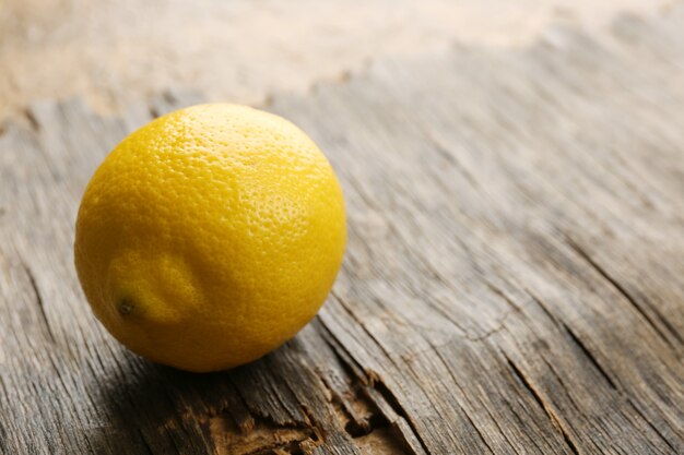 Fresh lemon on rustic wooden background