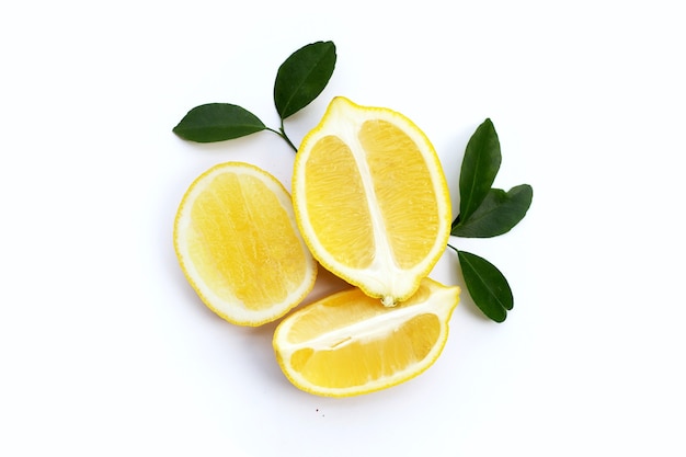 Fresh lemon with green leaves isolated