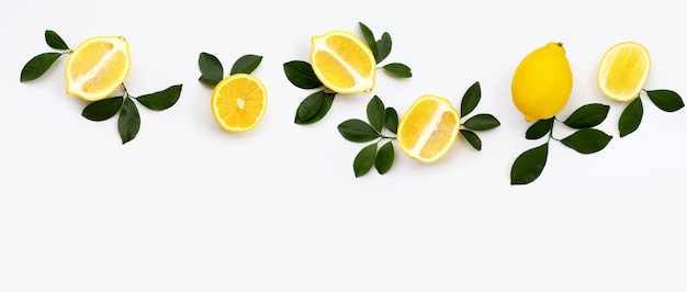 Fresh lemon with green leaves on white background.