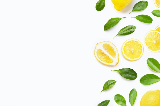 Fresh lemon with green leaves on white background