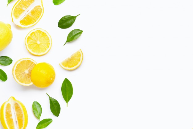 fresh lemon with green leaves on white. 