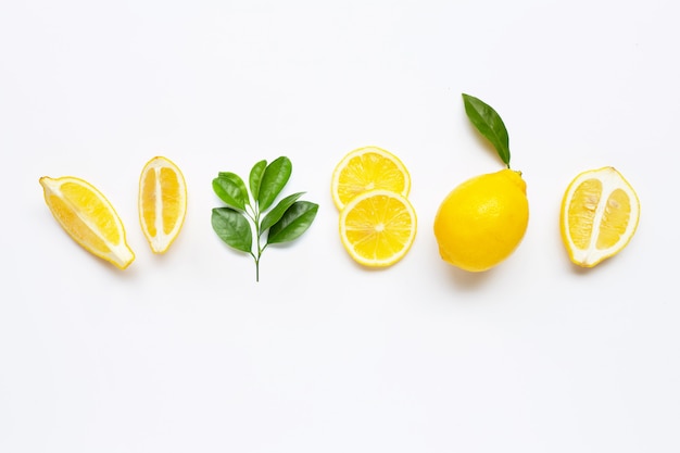 Fresh lemon with green leaves on white.