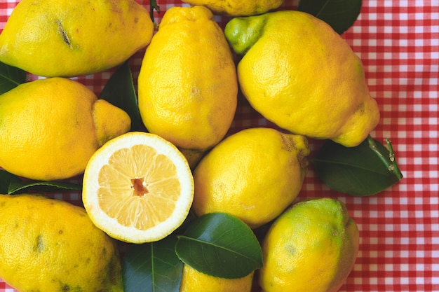 Fresh lemon with leaves on red  tablecloth