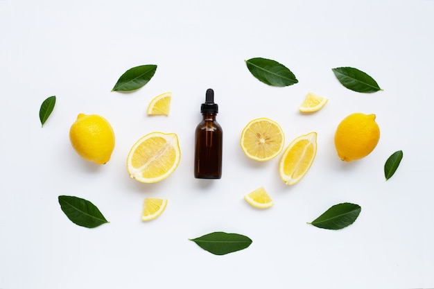 Fresh lemon with lemon essential oil on  white background.