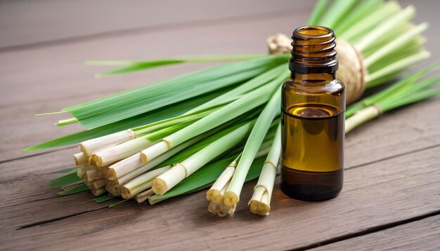 Photo fresh lemongrass leaves with essential oil bottle on table lemongrass is a tropical grassy plant used in cooking and herbal medicine extracted from the leaves and stalks