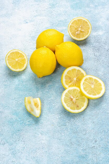 Fresh lemons on bright background Lemon fruit citrus Composition with whole slices of lemons