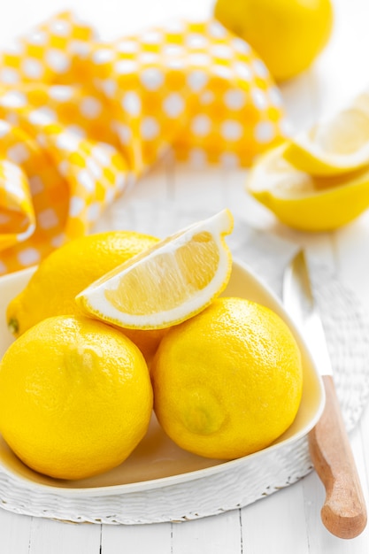 Fresh lemons on a ceramic bowl