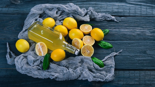 Fresh Lemons and Lemon Juice On a wooden background Top view Free space for your text