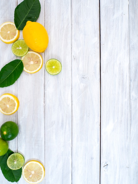 Fresh lemons on the white wooden background