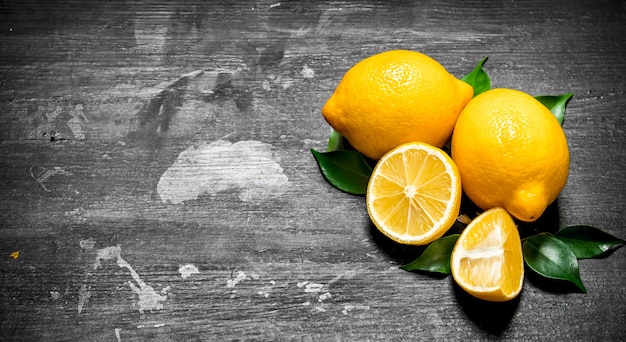 Fresh lemons with green leaves.