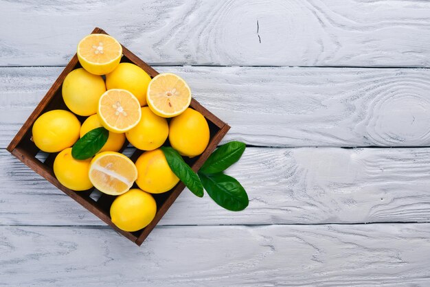 Fresh lemons On a wooden background Top view Free space for your text