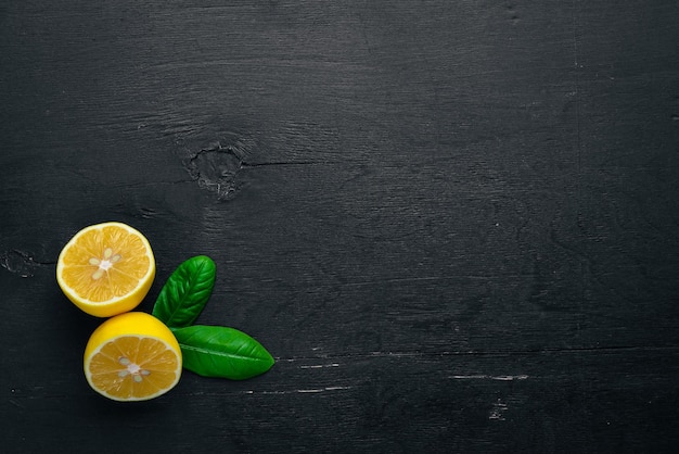 Fresh lemons On a wooden background Top view Free space for your text