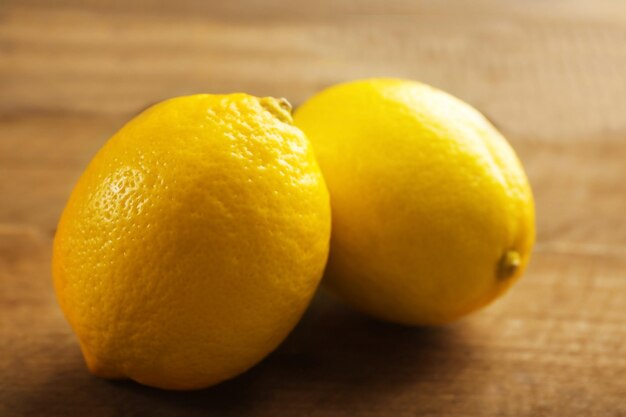 Fresh lemons on wooden background