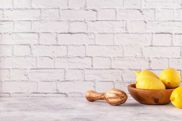 Fresh lemons in a wooden bowl