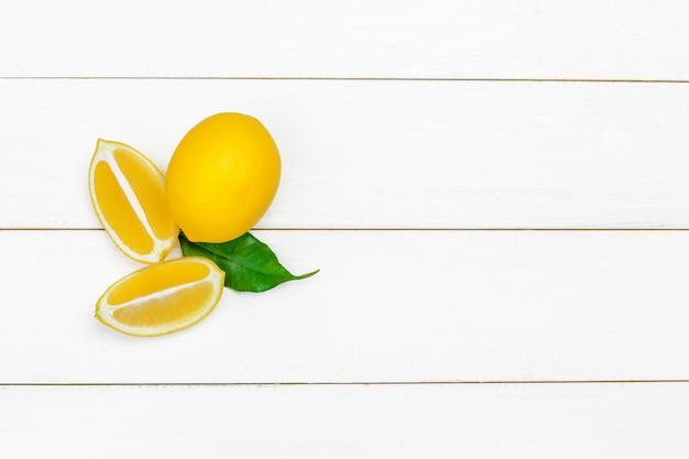 Fresh lemons on wooden table.