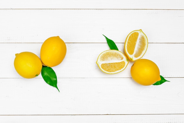 Fresh lemons on wooden table.