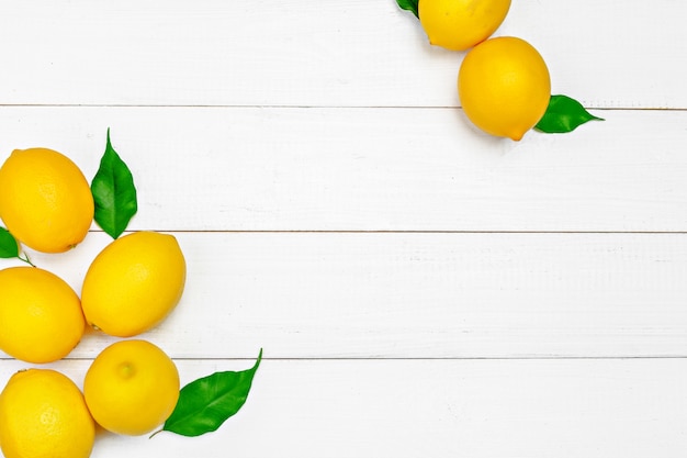 Fresh lemons on wooden table.