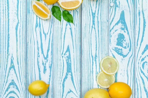 Fresh lemons on wooden table.