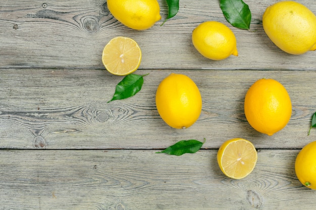 Fresh lemons on wooden table.