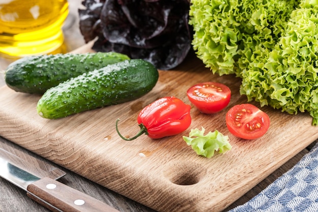 Fresh lettuce and other vegetables on cutting board