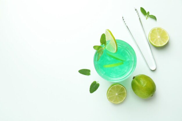 Fresh lime cocktail and ingredients on white background