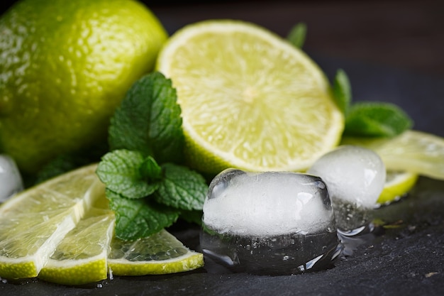 Fresh lime, mint and ice cubes. Dark