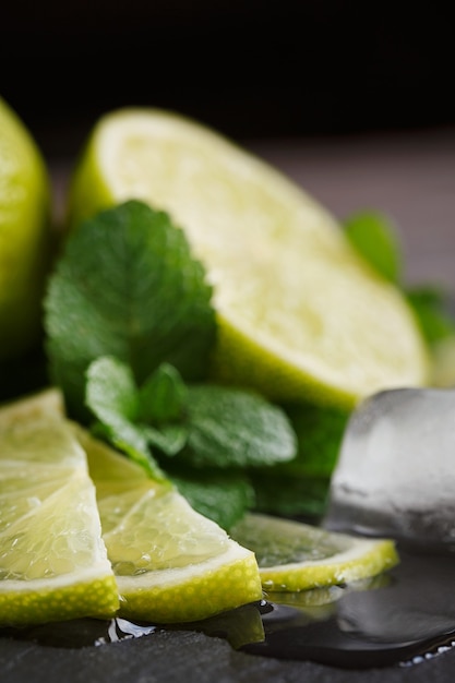 Fresh lime, mint and ice cubes. Dark