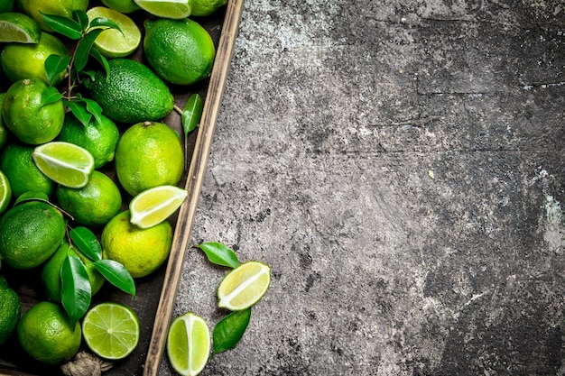 Fresh lime and slices of ripe lime on tray