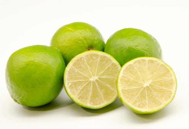 Fresh limes on white surface