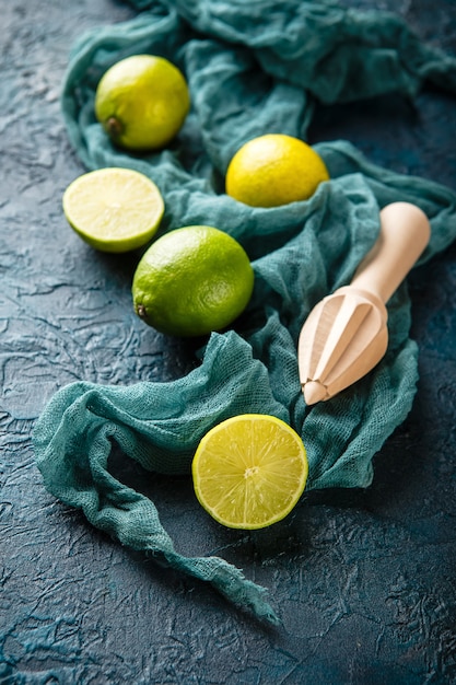 Fresh limes with citrus juicer stick.