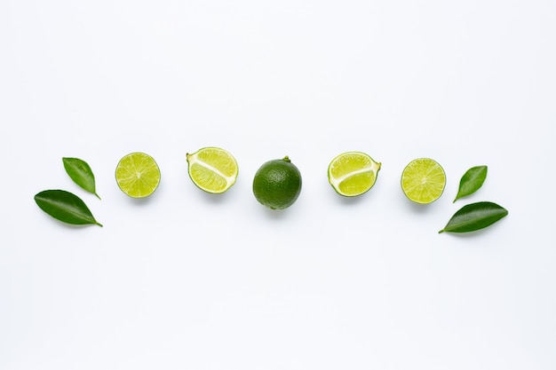 Fresh limes with leaves isolated on white.