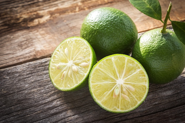 Fresh limes on wooden background.