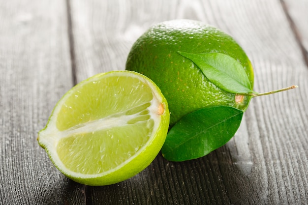 Fresh limes on wooden table