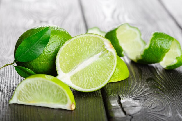 Fresh limes on wooden table