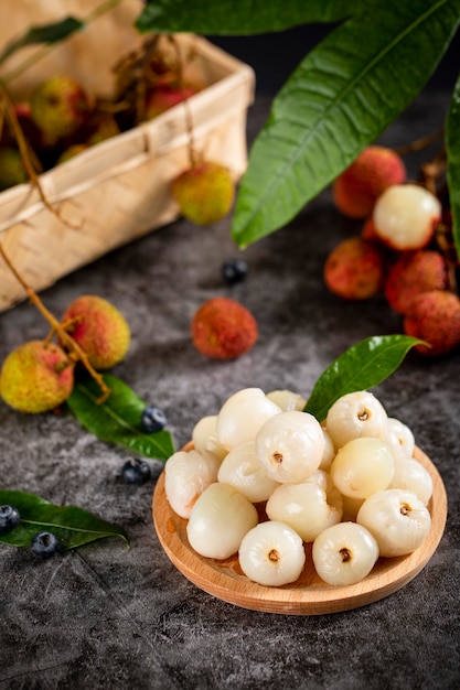 Fresh litchi fruit on wooden table