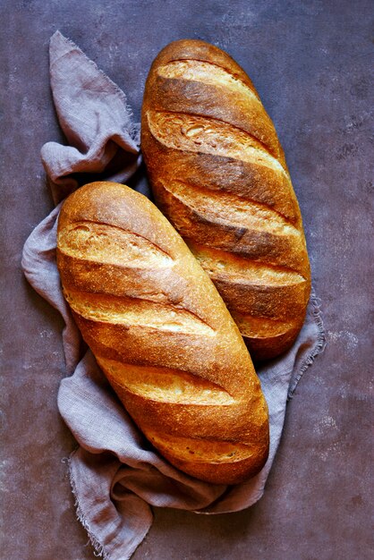 Fresh loaf on a brown wall.