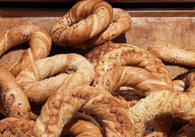 Fresh loaves of bread and buns in rustic bakery baked goods on rustic background and countryside food market